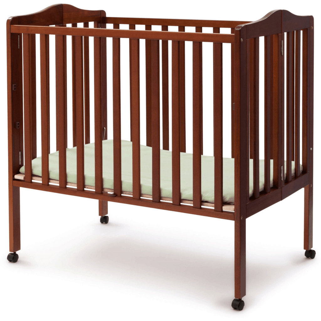 Delta Children Portable Mini Crib in cherry open on wheels in lower height setting for toddlers