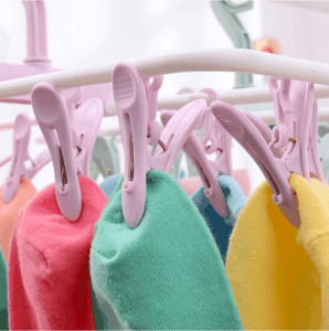Inoutdoorkit Hanger Rack closeup on light purple clips with drying socks