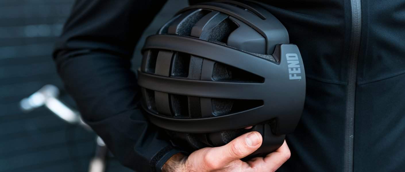 Fend helmet in black tucked under arm